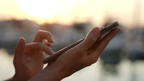 Close-up of holding the phone to access the Internet to communicate remotely on Видео 159331948