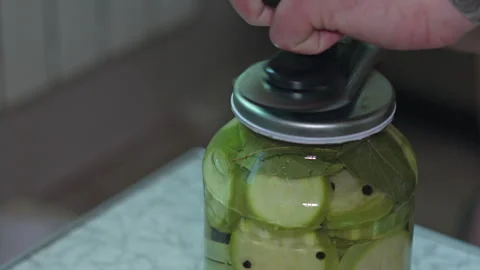 Close-Up of Home Canner Sealing a Jar of Pickled Summer Squash Vegetables Video stock 339647471