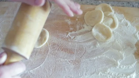 Close-up. Home cooking process of dumplings. Female hands roll out the dough on Stock Footage 74216255