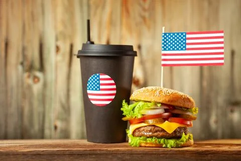 Close-up home made beef burger with american flag on the top and cup on woode Stock Illustration