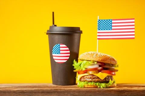 Close-up home made beef burger with american flag on the top and black paper  Stock Illustration