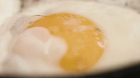 Close up of homemade eggs prepared in a stainless steel pan on gas hob for a Stock Footage 61752534