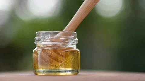 Close up honey be in bottle with comb Stock Footage 59764501