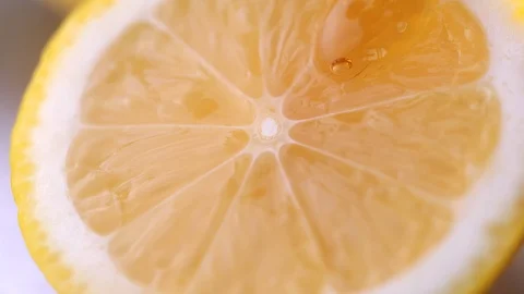 Close-up of Honey dripping on slice lemon in slow motion Video stock 126953271