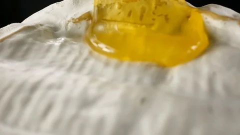 Close-up honey flows through camamber cheese Video stock 104974614