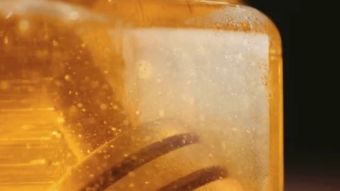 Close up of honey stick in jar Video stock 69997482