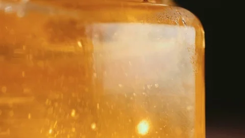 Close up of honey stick in jar Stock Footage 69997491