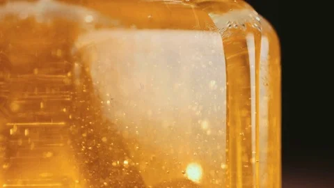 Close up of honey stick in jar Vídeos de archivo 69997499