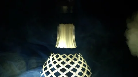 A close-up of the hookah finds thick light smoke on a black background, slow Stock Footage 128841696