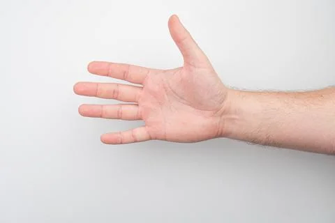 Close-up of a horizontal arm extension, hand facing upwards, slightly highlig Stock Photos