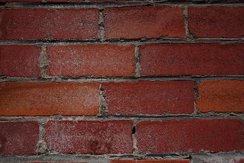 A close-up horizontal full-frame view of a weathered red brick wall Фото