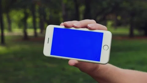 Close up Horizontal hands holding smartphone with blue screen. Blue screen Stock Footage 171160804