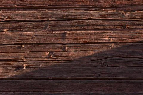 A close up horizontal image showing a rustic red painted wooden log wall back Photos