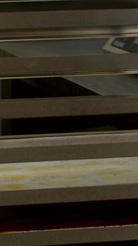 Close-up of horizontal shelving with utensils revealed behind slat in kitchen Видео 344572828