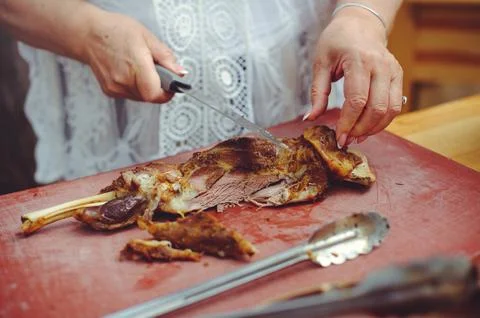 A close-up horizontal shot of a person's hands using a knife to carve a suc.. Stock Photos