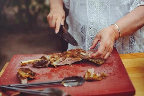 A close-up horizontal shot of a person's hands using a knife to carve a suc.. Stock Photos