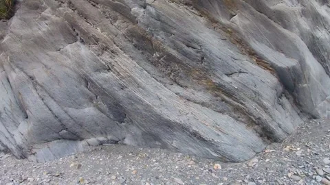 Close up horizontal view to bottom of a huge boulder rock with layers of texture Stock Footage 265493575