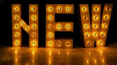 Close up of horizontally placed letters that make up the word new Foto stock