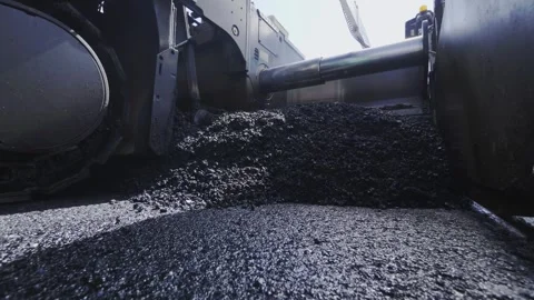 Close-Up of Hot Asphalt Material Moving Under Paver Machine Screed Stock Footage 322195710