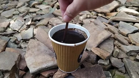Close-up of a hot black coffee served in a brown disposable paper cup Stock Footage 324705762
