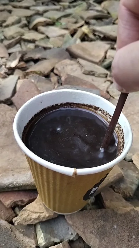 Close-up of a hot black coffee served in a brown disposable paper cup Stock Footage 324705769