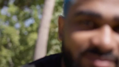 Close-up hot from blurred to focused of cheerful black man smiling Stock Footage 287488867