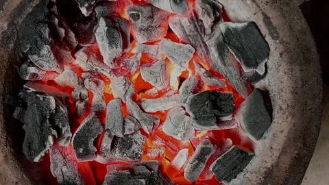 Close up of hot burning black pieces of charcoal with sparks in coal pot. Stock Footage 312304845