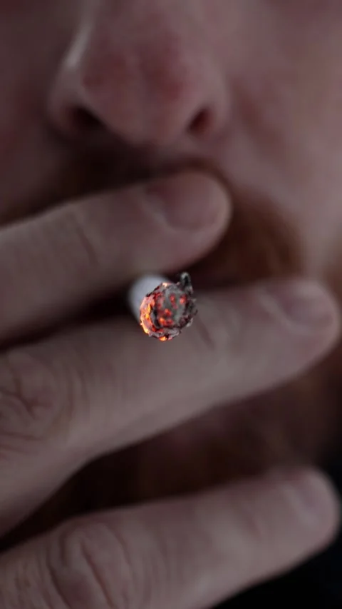 Close-up of hot burning ember of a cigarette. A man smokes Stock Footage 321353356