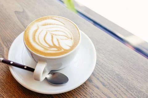 Close-up of hot cappuccino coffee dressing with leave shape of latte art Stock Photos