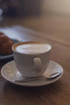 Close up hot cappuccino, latte on table with blur coffee shop background. Hot Stock Photos