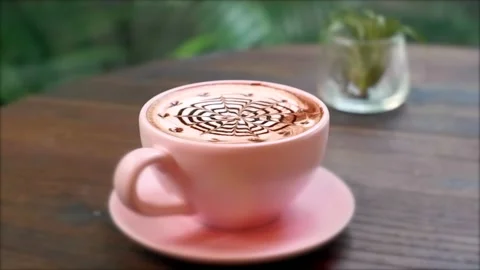 Close-up of Hot Ceramic Pink Coffee Cup on Saucer with Chocolate Latte Art Stock Footage 162407409