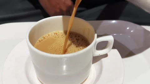 Close Up of Hot Chai tea Being Poured into a White Ceramic Cup Video stock 340974783