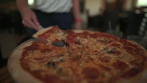 Close-up of hot, cheesy pizza with slice being lifted, showcasing stretchy Stockbeeldmateriaal 295168299