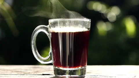 Close up hot coffee in clear glass coffee cup, mug on old wooden table Stock Footage 204865415