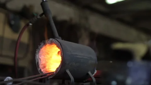Close-up of the hot face of the master of blacksmithing at work. In the Stock Footage 135744401