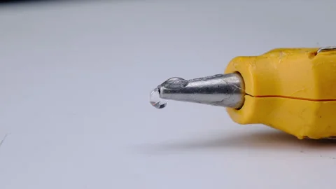 Close-up of hot glue coming out of a glue gun.  Video stock 260774809