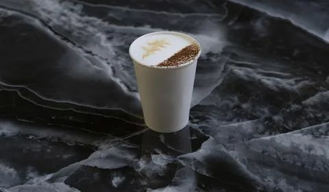 Close-up Hot latte with a cocoa parcel against the background of black marble in Stock Photos