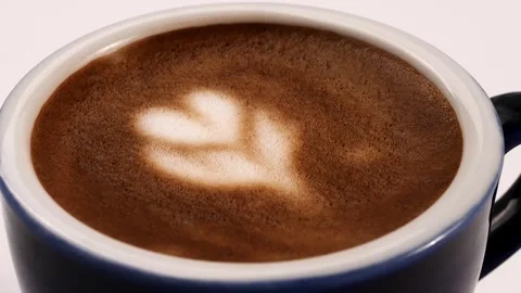 Close up of hot latte foam starting to disappear in the breeze inside the cerami Stock Footage 320768266