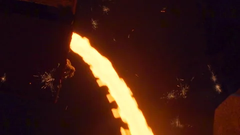 Close up on hot liquid iron cast flowing and sparkles Stock Footage 249620723