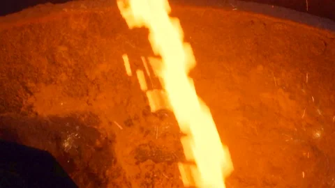 Close up on hot liquid iron cast flowing and making sparkles Stock Footage 249620740