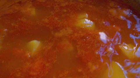 Close-up of hot meat soup with potatoes boiling in a cauldron. Stock Footage 335583529