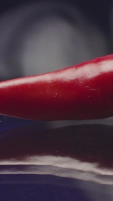 Close-up of hot pepper with smoke. Stock footage. Red chili pepper on isolated Stock Footage 289640832
