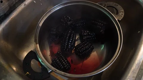 Close up of hot purple corn in a kitchen pot on the sink Stock Footage
