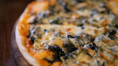 Close-up of hot Spinach and Cheese Pizza with melted mozzarella on wooden board Video stock 329347638