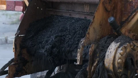 Close up of hot steaming fresh asphalt pouring from construction machinery .. Stock Footage 339801794