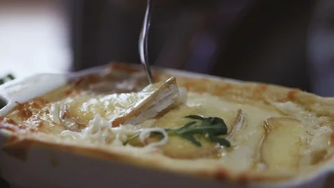 Close-up of hot stretching cheese on a fork. A young woman sitting in a Stock Footage 106237954