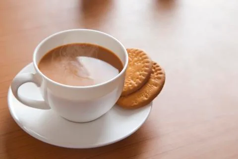 Close-up of hot tea and biscuits on table Stock Photos