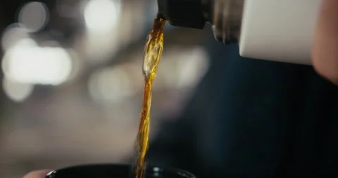 Close-up of hot tea being poured into silver thermos cup. Stock Footage 300801593