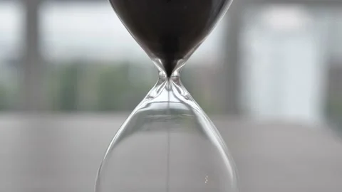 Close-up of an hourglass on a blurred background. Time is fleeting Stock Footage 176483201