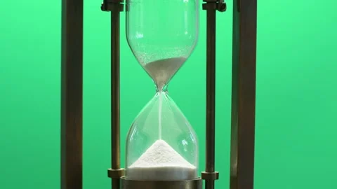 Close-up of hourglass measuring passing time with running sand on green screen Stock Footage 140808318